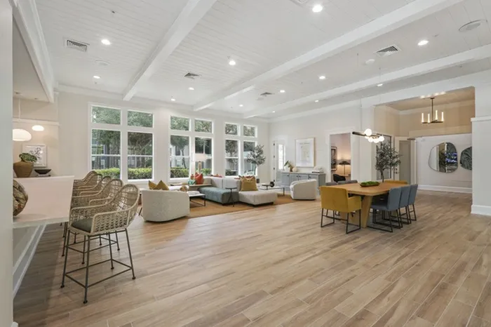 Image of Lantower Cypress Creeks' newly-renovated clubhouse with stylish wallpaper, modern furniture, and ceiling to floor windows with ample natural sunlight.