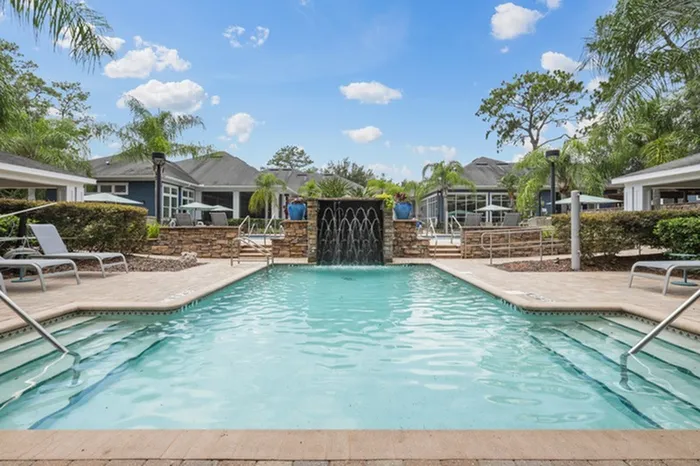 Image of resort-style pool and hot tub with sundeck and lounge chairs at Lantower Cypress Creek.