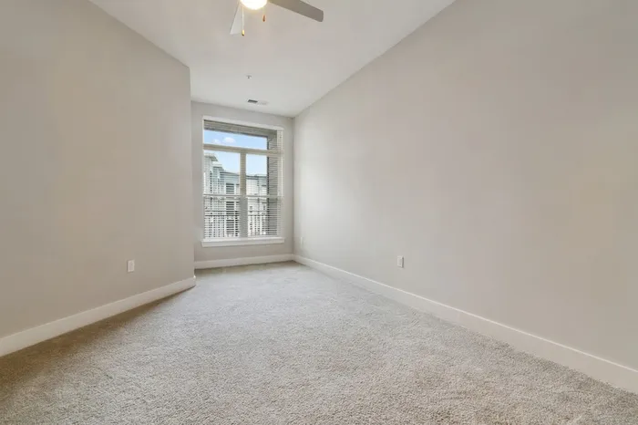 Carpeted bedroom with a large window at Bullhouse.