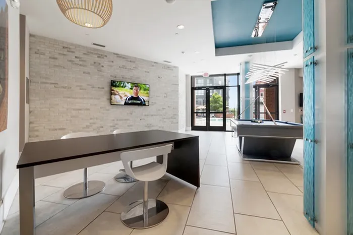 Clubhouse with a billiard table and bar seating area at Lantower Bullhouse.