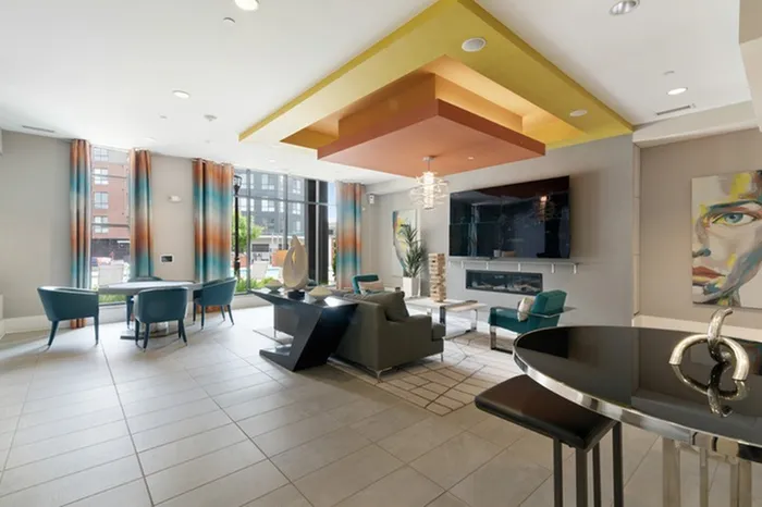 Clubhouse with ample seating, a fireplace, and a wall-mounted TV at Lantower Bullhouse.