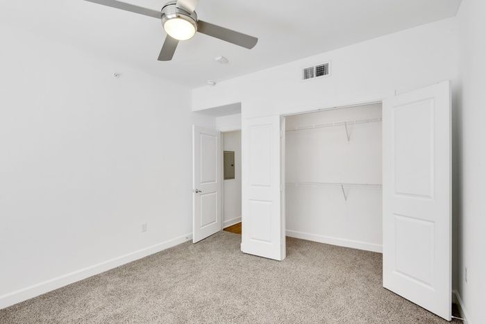Spacious bedroom with ample room for furniture, natural sunlight, large closet and classic finishes at Lantower Ambrosio Apartments.