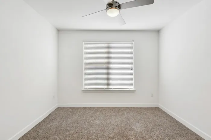 Spacious bedroom with ample room for furniture, natural sunlight and classic finishes at Lantower Ambrosio Apartments.