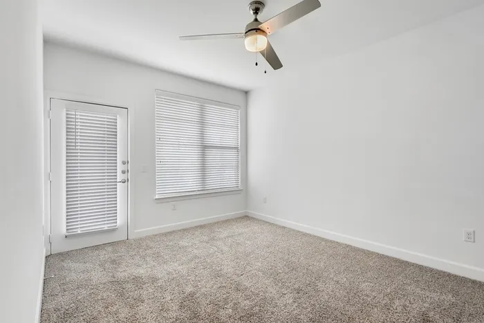 Spacious bedroom with ample room for furniture, natural sunlight and classic finishes at Lantower Ambrosio Apartments.