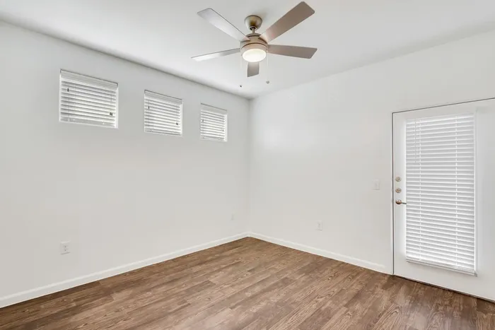 Spacious living room with ample room for seating, natural sunlight, and classic finishes at Lantower Ambrosio Apartments.