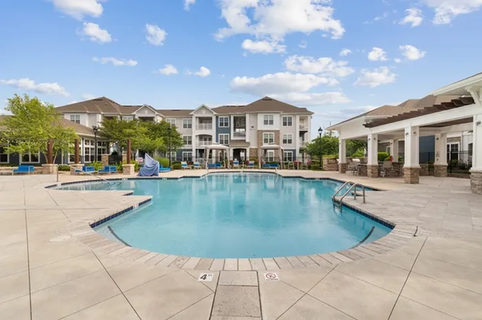 Resort-Style Saltwater Pool Area with Sun Shelf at Realm at Patterson Place Apartments.