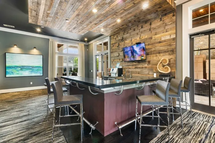 Resident clubroom with a coffee machine and bar-style area at Patterson Place Apartments.
