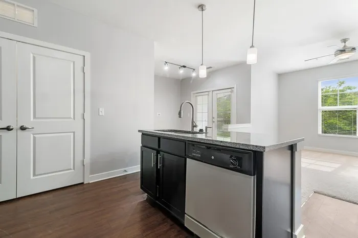 Energy-efficient kitchen with granite countertops, stainless steel appliances, and a kitchen island at Realm at Patterson Place.