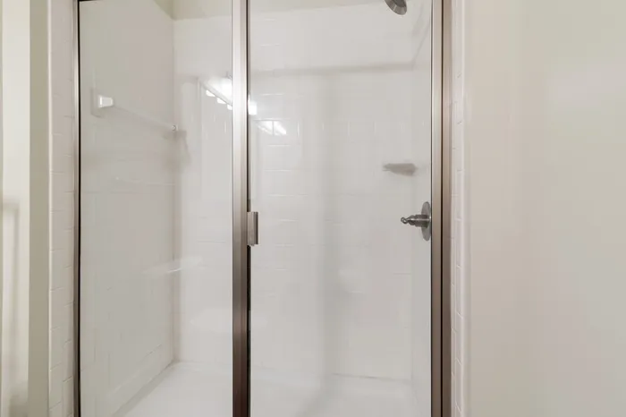 Walk-in, glass door shower at Realm at Patterson Place.