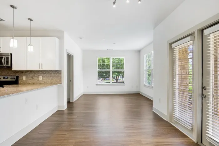 Living room with five large windows and a door accessing the backyard at Lantower Waverly.