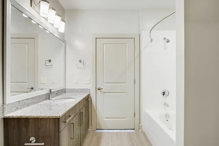 Bathroom at Lantower Waverly with wood-style flooring and a soaking tub.