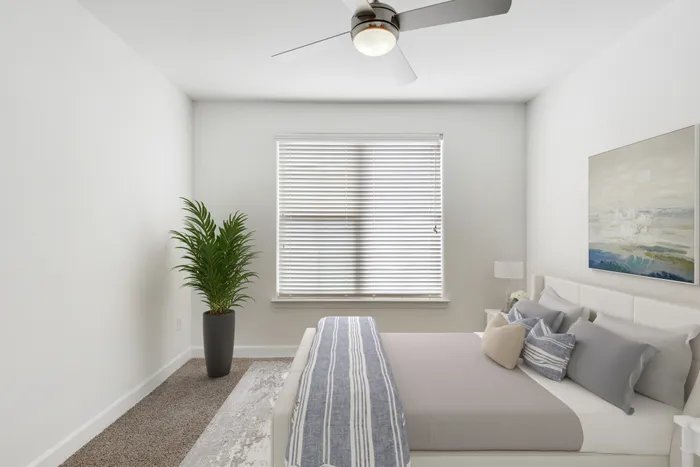 Spacious bedroom with ample room for furniture, natural sunlight and classic finishes at Lantower Ambrosio Apartments.