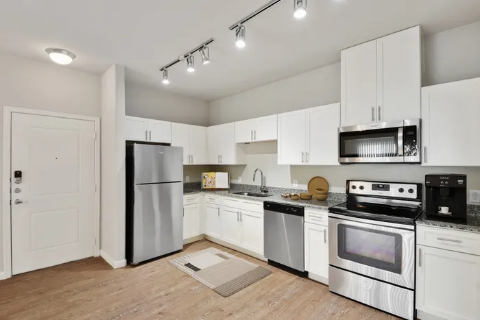 Apartment Kitchen with granite countertops and stainless steel appliances at Lantower Edgewater
