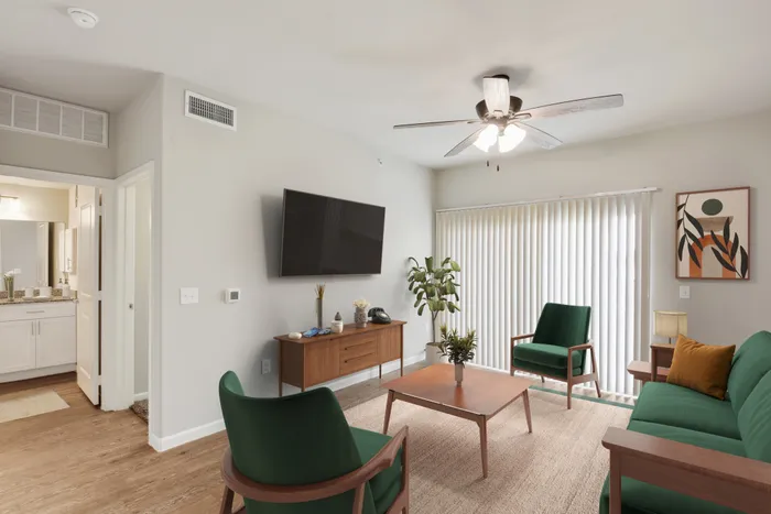 Spacious living room with hardwood floors and a ceiling fan at Lantower Edgewater