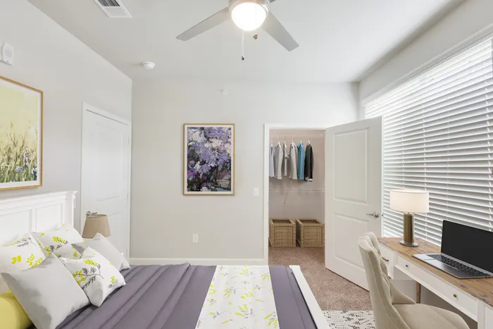 Bedroom with carpet flooring, a walk-in closet and natural lighting with a large window at Lantower Edgewater
