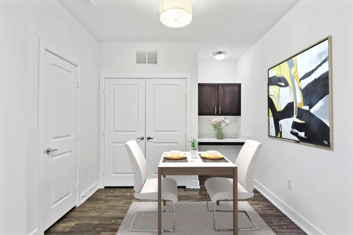 Spacious room with office space, dark wood-stained cabinets, vinyl plank flooring and closet access at Lantower Techridge apartments