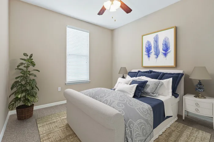 Bedroom with carpet, a ceiling fan, a large white, plush bed, blue wall art, a large houseplant and a large window at Lantower Asturia.