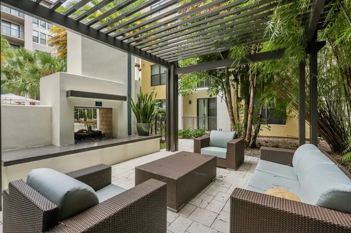 Lantower Westshore courtyard with ample seating, grills, fireplace, and pergola.