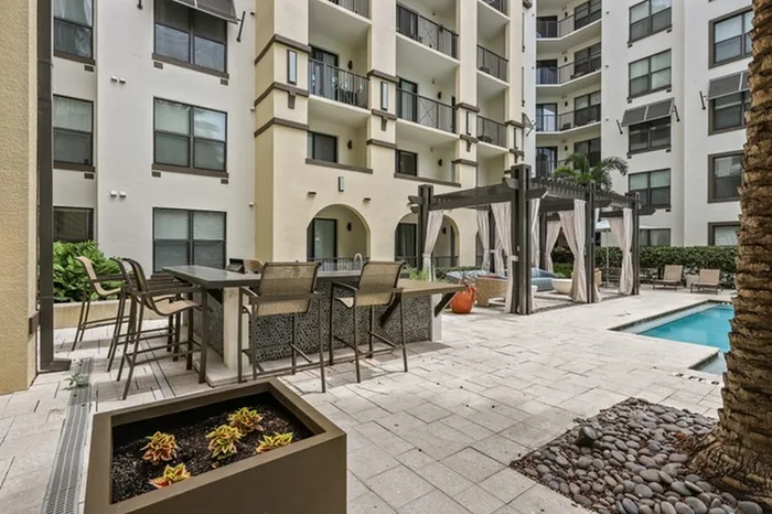 Resort-style swimming pool with grills and ample relaxing cabana seating at Lantower Westshore.