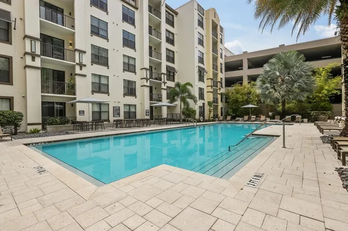 Resort-style swimming pool with sundeck, grills, and ample relaxing cabana seating at Lantower Westshore.