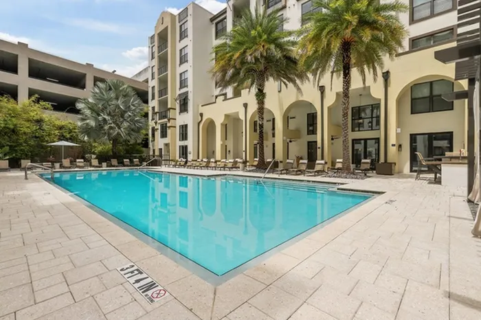 Resort-style swimming pool with sundeck, grills, and ample relaxing cabana seating at Lantower Westshore.