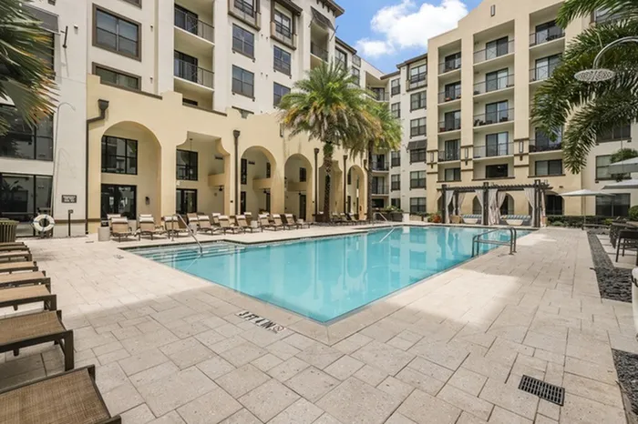 Resort-style swimming pool with sundeck, grills, and ample relaxing cabana seating at Lantower Westshore.