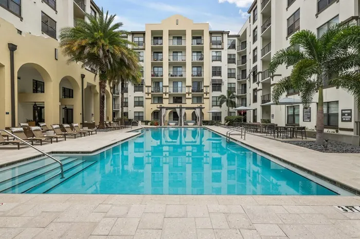 Resort-style swimming pool with sundeck, grills, and ample relaxing cabana seating at Lantower Westshore.