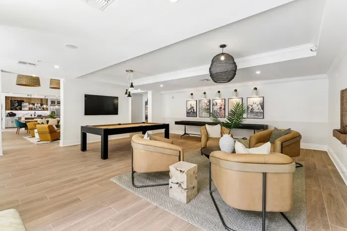 Clubhouse with billiards table, shuffleboard, full kitchen, wall-mount television, and ample seating at Lantower Westshore.