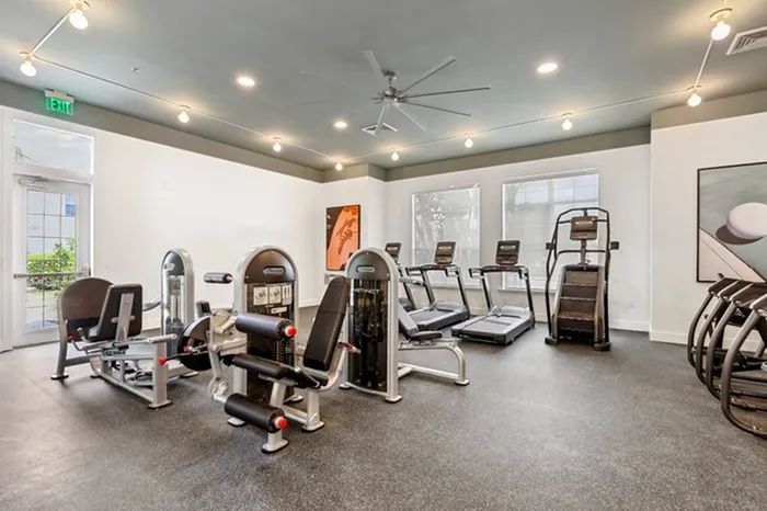 State-of-the-art fitness center at Lantower Tortuga Bay with cardio machines, weight machines, and Stairmaster.
