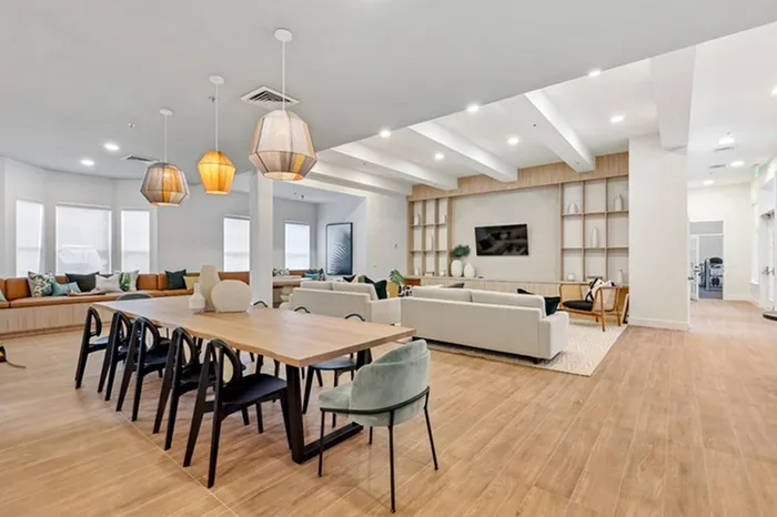 Clubhouse at Lantower Tortuga Bay with ample seating, bright lighting, wood-style floors, flat screen television, and complimentary Wi-Fi.