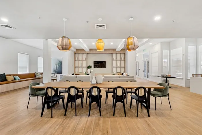 Clubhouse at Lantower Tortuga Bay with ample seating, bright lighting, wood-style floors, flat screen television, and complimentary Wi-Fi.