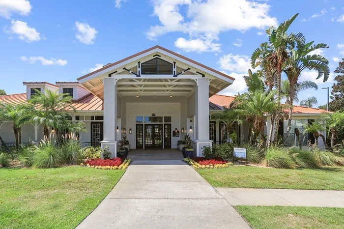 Tortuga Bay at Waterford lakes entry with lush landscape.