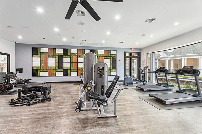 Spacious fitness center with cardio and strength training equipment.