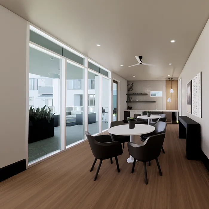 Modern dining area with sleek furniture, large windows offering natural light, and an open view to a stylish kitchen.
