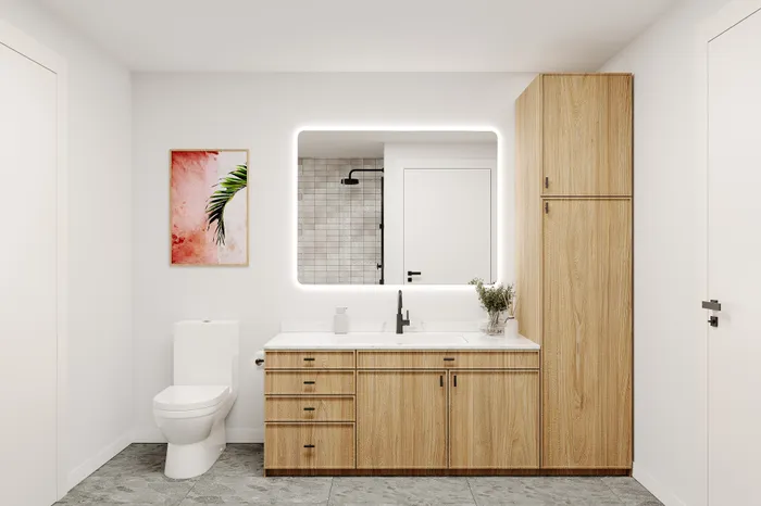 Modern bathroom with elegant wooden cabinetry, illuminated mirror, sleek white toilet, and stylish art on the wall creating a serene atmosphere.