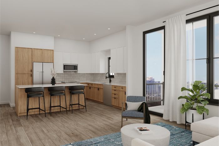 Modern open-concept kitchen with sleek wooden cabinetry, elegant island seating, and large windows offering a stunning view.