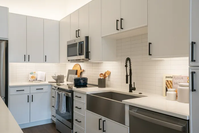 Modern gourmet kitchen with sleek cabinetry, stainless steel appliances, and elegant subway tile backsplash.