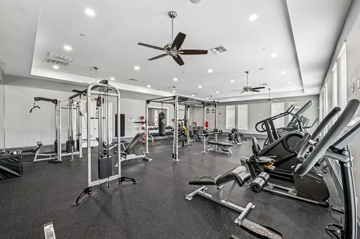 Modern fitness center with state-of-the-art equipment, bright lighting, and a spacious workout area.