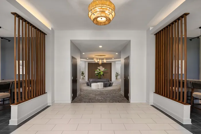 Lounge at Lantower Waverly with plush seating and modern chandeliers and décor.