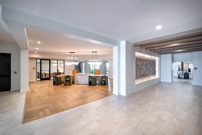 Luxurious open lobby with elegant stone accent wall, modern lighting, and chic seating area.