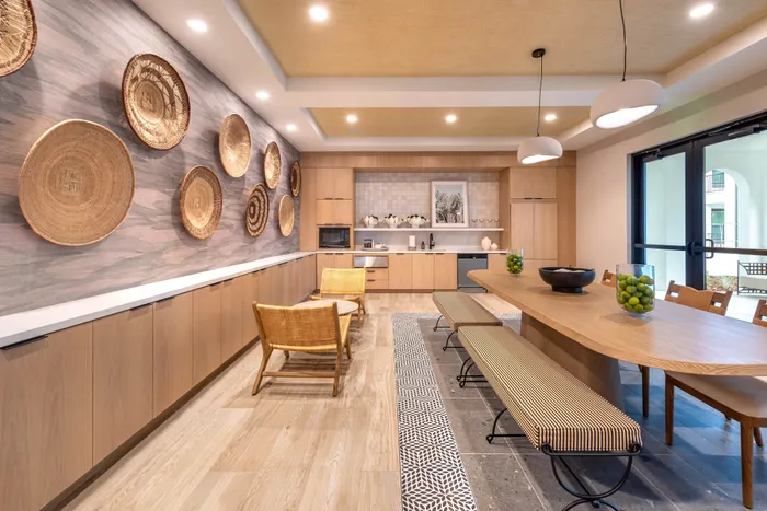 Elegant dining area with stylish wooden decor, cozy seating, and decorative woven wall accents, offering a bright and welcoming atmosphere.
