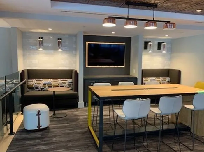 A mezzanine level resident lounge with television and many gathering areas