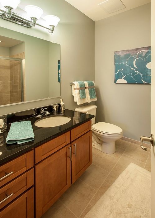 Large Bathroom With Tiled Shower, Granite Vanity Counter, Ample Storage Space & Modern Lighting | Madison at Ballston Station | Arlington VA Apartments