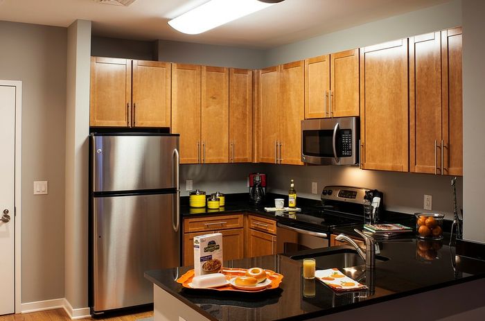Contemporary Kitchen With Granite Countertops, Wood Cabinets & Stainless Steel Appliances | Madison at Ballston Station | Arlington VA Apartments