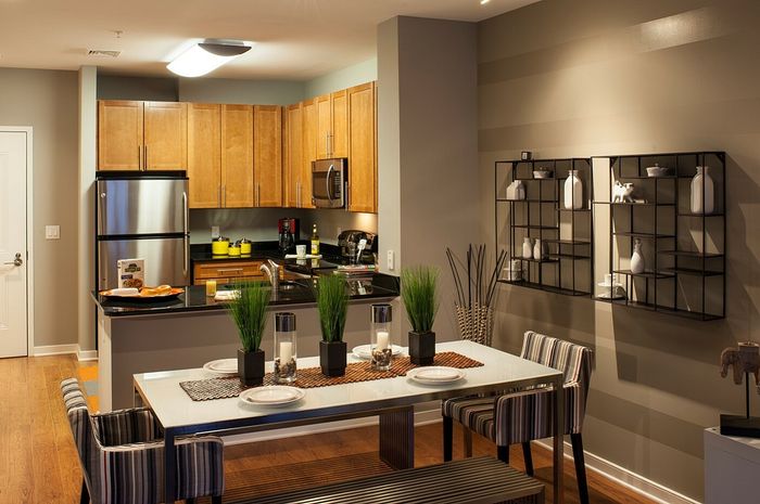 Dining Area & Contemporary Kitchen With Granite Countertops,  Wood Cabinets & Stainless Steel Appliances |  Madison at Ballston Station | Arlington VA Apartments