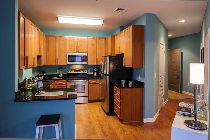 Contemporary Kitchen With Granite Countertops, Wood Cabinets & Stainless Steel Appliances | Madison at Ballston Station | Arlington VA Apartments
