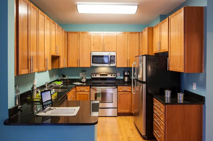Contemporary Kitchen With Granite Countertops, Wood Cabinets & Stainless Steel Appliances | Madison at Ballston Station | Arlington VA Apartments