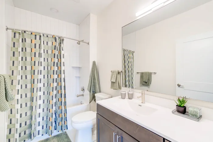 Primary Bathroom With Ceramic Tile Flooring & Bath Surround With Large Storage-Friendly Vanity | Indigo at McLean Station | Affordable Tysons Corner Apartments | Affordable Fairfax VA Apartments | Affordable McLean Apartments
