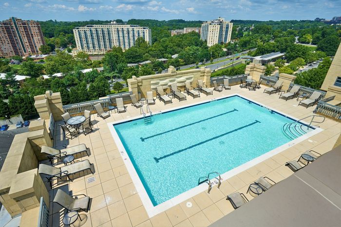 Relax at the rooftop swimming pool with two marked lap lanes and expansive sundeck at Meridian at Grosvenor Station, offering a luxury outdoor oasis with panoramic views of North Bethesda and easy access to the nearby Grosvenor-Strathmore | Luxury North Bethesda MD Apartments | Luxury Rockville MD Apartments