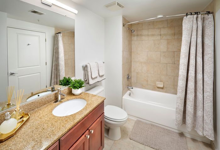 Renovated Ellington One Bedroom bathroom with granite vanity, custom cabinets, and updated lighting and fixtures | Meridian at Grosvenor Station | Luxury North Bethesda MD Apartments | Luxury Rockville MD Apartments